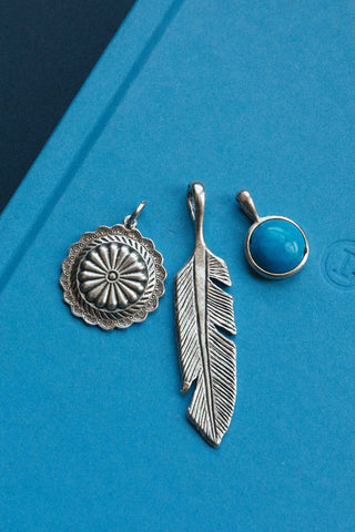 vintage silver charm set with large feather concho shell and turquoise gemstone	