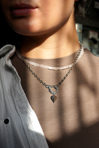 Waterproof heart charm on stainless steel necklace on model - tarnish resistant brass jewelry