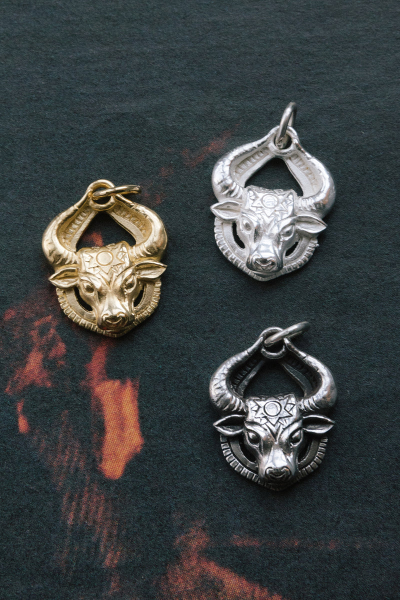 14kt gold sterling silver and antiqued silver charging bull pendants	